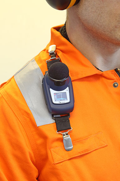 Casella dBadge noise dosimeter being worn by worker on shoulder